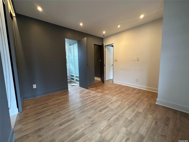 9-01 127th St, College Point, NY 11356 - spare room with wood finished floors, baseboards, and recessed lighting
