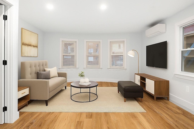 3919 Murdock Ave, Bronx, NY 10466 - living area featuring an AC wall unit and light wood finished floors