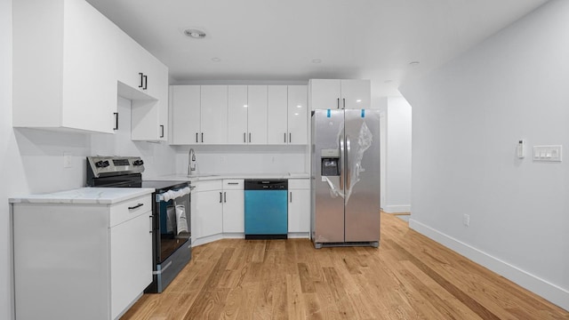 3919 Murdock Ave, Bronx, NY 10466 - kitchen featuring stainless steel appliances, light wood-style floors, and white cabinetry