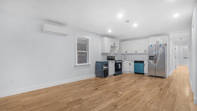 3919 Murdock Ave, Bronx, NY 10466 - kitchen featuring appliances with stainless steel finishes, a wall unit AC, white cabinets, light countertops, and light wood-type flooring