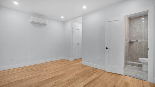 3919 Murdock Ave, Bronx, NY 10466 - unfurnished bedroom with a wall mounted AC, wood finished floors, ensuite bath, and recessed lighting