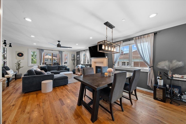 435 E Broadway Unit A, Long Beach, NY 11561 - dining area with crown molding, a glass covered fireplace, light wood-style flooring, recessed lighting, and ceiling fan