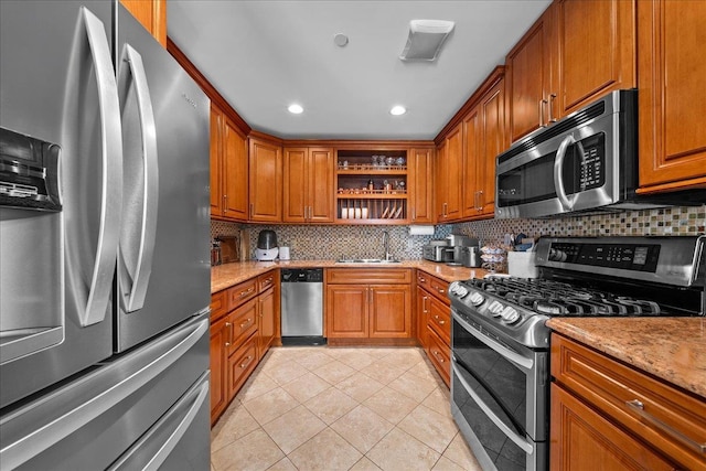 435 E Broadway Unit A, Long Beach, NY 11561 - kitchen featuring appliances with stainless steel finishes, open shelves, brown cabinets, light tile patterned flooring, and tasteful backsplash