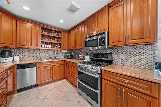 435 E Broadway Unit A, Long Beach, NY 11561 - kitchen with appliances with stainless steel finishes, open shelves, brown cabinets, and light tile patterned floors