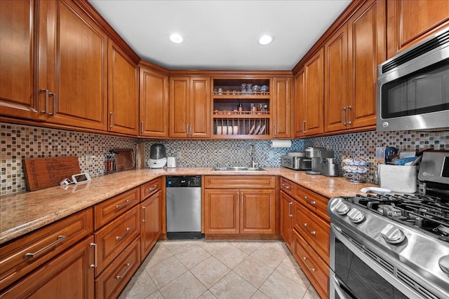 435 E Broadway Unit A, Long Beach, NY 11561 - kitchen with stainless steel appliances, brown cabinetry, light tile patterned flooring, and open shelves