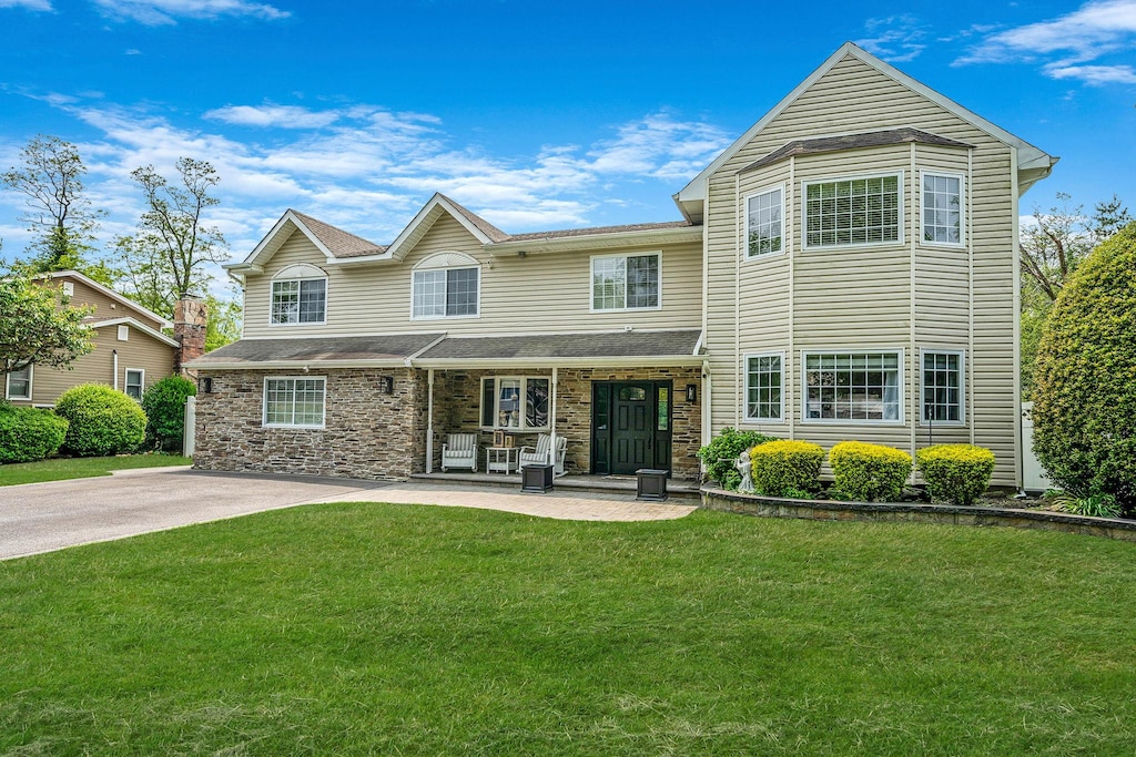 33 Stonywood Dr, Commack, NY 11725 - view of front of house with a front yard and stone siding