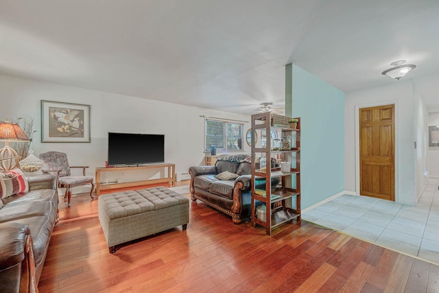 114 Oakwood Dr, Wading River, NY 11792 - living room with light wood-type flooring, a ceiling fan, a baseboard radiator, and baseboards