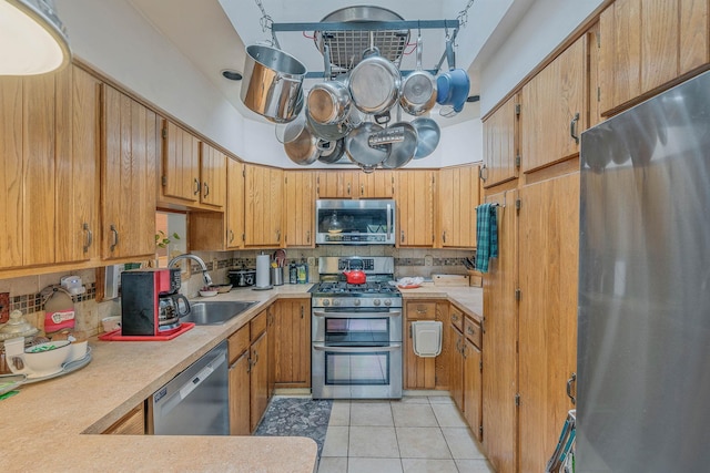 114 Oakwood Dr, Wading River, NY 11792 - kitchen with appliances with stainless steel finishes, a sink, backsplash, and light tile patterned floors