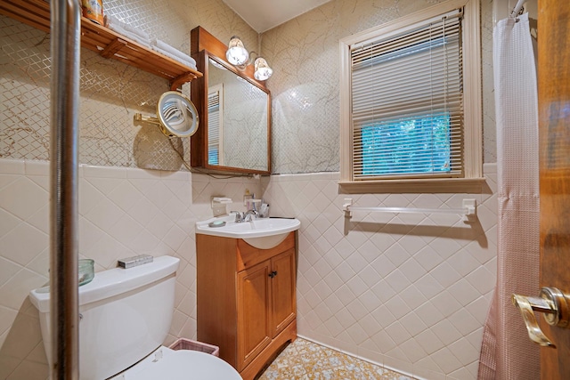 114 Oakwood Dr, Wading River, NY 11792 - bathroom featuring tile walls, vanity, toilet, and wainscoting
