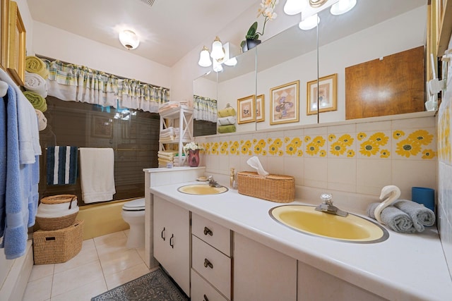 114 Oakwood Dr, Wading River, NY 11792 - bathroom featuring double vanity, tile patterned flooring, toilet, bathing tub / shower combination, and tile walls