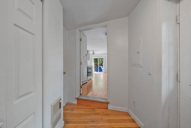 114 Oakwood Dr, Wading River, NY 11792 - corridor featuring light wood-style flooring, electric panel, baseboards, and a baseboard heating unit