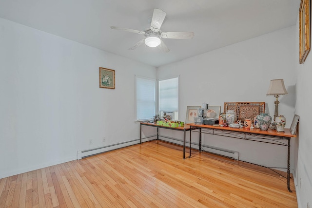 114 Oakwood Dr, Wading River, NY 11792 - empty room with hardwood / wood-style flooring, a desk, ceiling fan, and a baseboard radiator