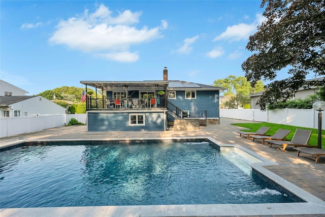 15 Fairway Dr, Old Bethpage, NY 11804 - rear view of property with roof mounted solar panels, a patio area, a chimney, a fenced backyard, and stairs