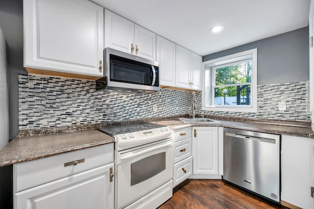 15 Fairway Dr, Old Bethpage, NY 11804 - kitchen featuring appliances with stainless steel finishes, white cabinetry, dark wood finished floors, dark countertops, and recessed lighting
