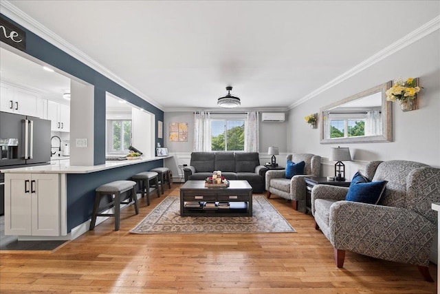 200 Merrick Rd Unit R, Amityville, NY 11701 - living area featuring a wall mounted AC, healthy amount of natural light, crown molding, and light wood-style flooring
