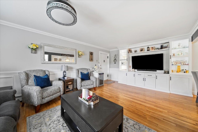 200 Merrick Rd Unit R, Amityville, NY 11701 - living area with ornamental molding, light wood-style floors, wainscoting, a baseboard radiator, and a decorative wall