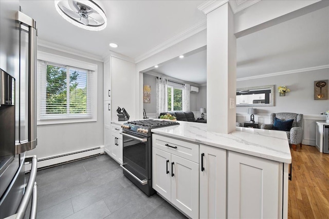 200 Merrick Rd Unit R, Amityville, NY 11701 - kitchen with range with gas stovetop, open floor plan, a baseboard heating unit, crown molding, and light stone countertops