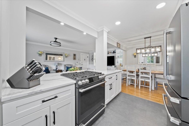 200 Merrick Rd Unit R, Amityville, NY 11701 - kitchen featuring gas range oven, high end refrigerator, crown molding, recessed lighting, and white cabinetry