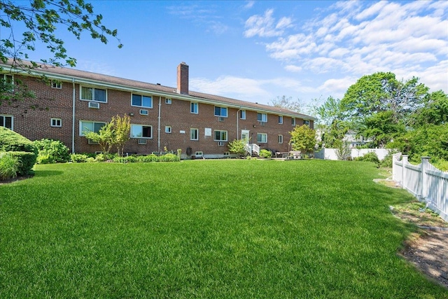 200 Merrick Rd Unit R, Amityville, NY 11701 - back of house featuring a chimney and brick siding