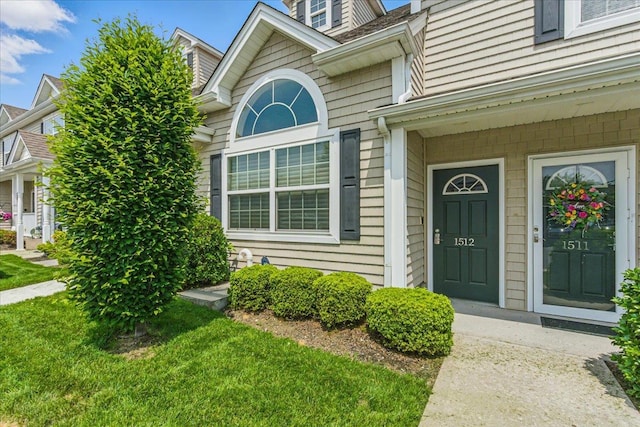 1512 Willow Ln, Valley Stream, NY 11580 - view of exterior entry with a yard
