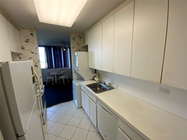 27110 Grand Central Pkwy Unit 11A, Floral Park, NY 11005 - kitchen with white appliances, a sink, light countertops, light tile patterned floors, and white cabinets