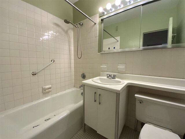 27110 Grand Central Pkwy Unit 11A, Floral Park, NY 11005 - full bath featuring tile walls, tub / shower combination, vanity, toilet, and tile patterned floors