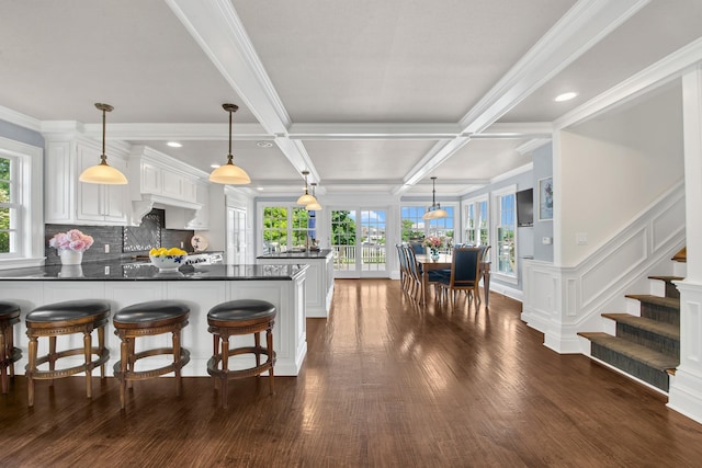 161 Wampum Ln, West Islip, NY 11795 - kitchen with a peninsula, dark countertops, white cabinetry, beamed ceiling, and crown molding