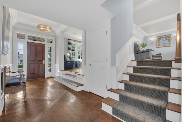 161 Wampum Ln, West Islip, NY 11795 - foyer featuring crown molding, a decorative wall, stairs, and wainscoting