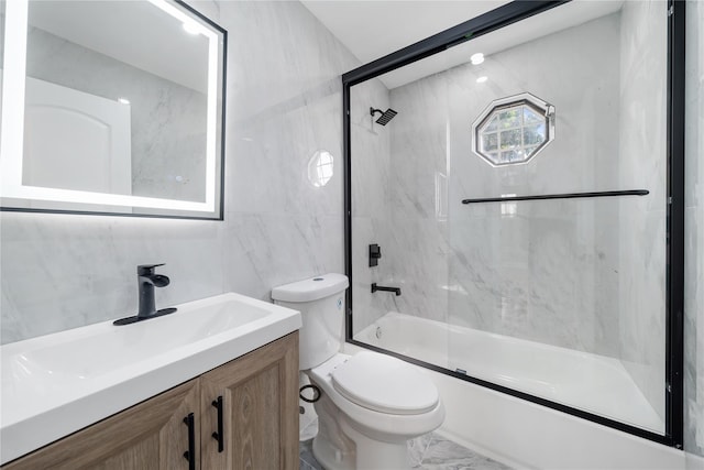 1779 Aladdin Ave, New Hyde Park, NY 11040 - full bath with toilet, vanity, bath / shower combo with glass door, tile walls, and marble finish flooring