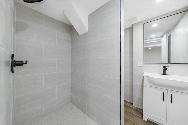 1779 Aladdin Ave, New Hyde Park, NY 11040 - full bathroom featuring a tile shower, vanity, and wood finished floors
