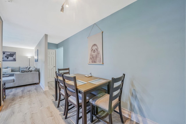 23 Edwards St Unit 1C, Roslyn Heights, NY 11577 - dining area featuring light wood finished floors and baseboards