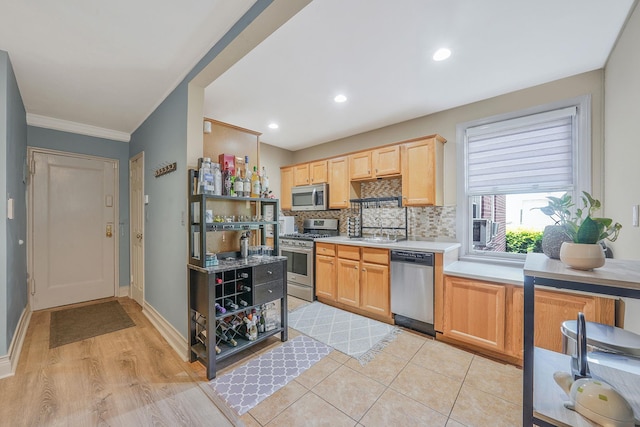 23 Edwards St Unit 1C, Roslyn Heights, NY 11577 - kitchen featuring stainless steel appliances, backsplash, light brown cabinets, light countertops, and a sink
