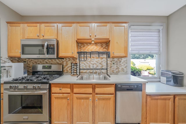 23 Edwards St Unit 1C, Roslyn Heights, NY 11577 - kitchen with stainless steel appliances, a sink, light countertops, and backsplash