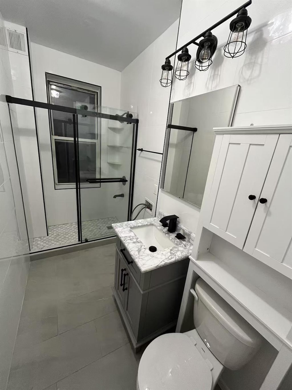 3591 161st St Unit 6L, Flushing, NY 11358 - full bathroom featuring vanity, toilet, a stall shower, and tile patterned floors