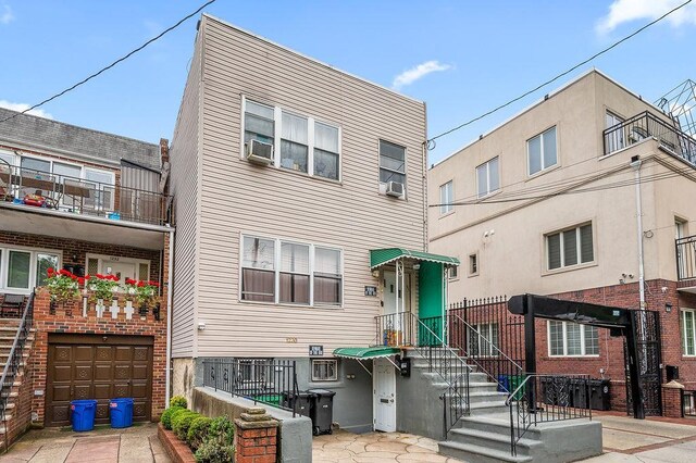 1230 59th St, Brooklyn, NY 11219 - townhome / multi-family property with an attached garage and cooling unit