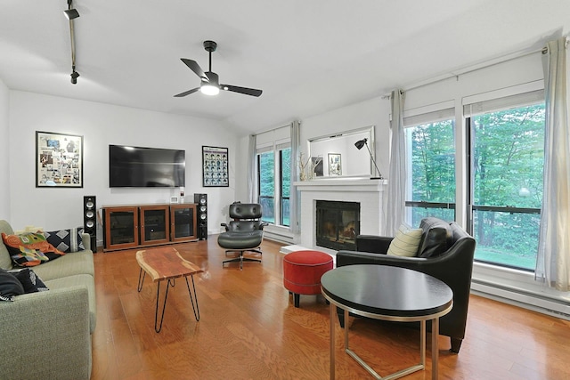 963 Heritage Hls Unit C, Somers, NY 10589 - living room featuring plenty of natural light, wood finished floors, a fireplace, a ceiling fan, and lofted ceiling