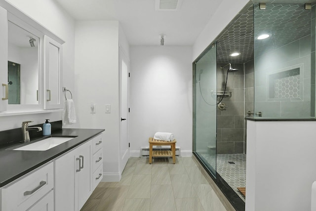 963 Heritage Hls Unit C, Somers, NY 10589 - full bathroom featuring a tile shower, vanity, a baseboard radiator, and baseboards