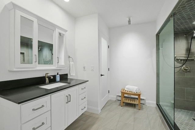 963 Heritage Hls Unit C, Somers, NY 10589 - full bathroom with a baseboard heating unit, vanity, tiled shower, and baseboards