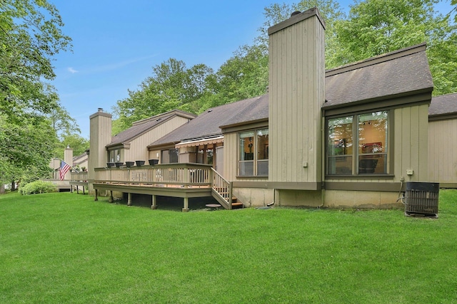 963 Heritage Hls Unit C, Somers, NY 10589 - rear view of house featuring a chimney, a yard, a wooden deck, roof with shingles, and central AC unit