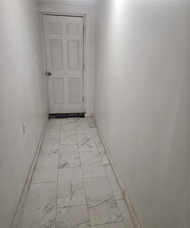 495 Milford St, Brooklyn, NY 11208 - hallway featuring light marble finish floors and baseboards