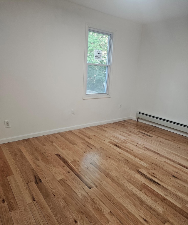 495 Milford St, Brooklyn, NY 11208 - spare room with wood finished floors and a baseboard heating unit