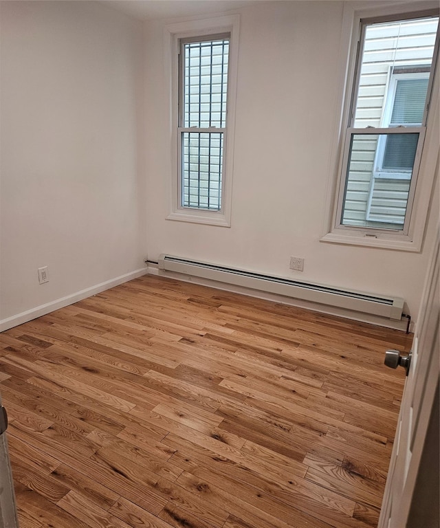 495 Milford St, Brooklyn, NY 11208 - empty room featuring a baseboard radiator and wood finished floors