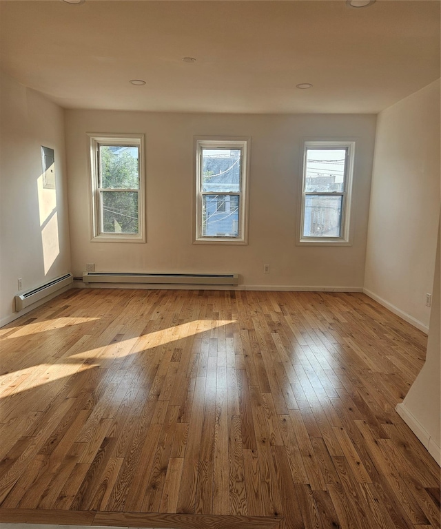 495 Milford St, Brooklyn, NY 11208 - empty room featuring hardwood / wood-style flooring, plenty of natural light, and a baseboard heating unit