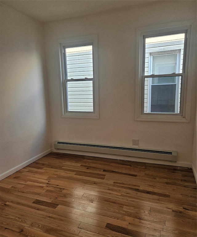 495 Milford St, Brooklyn, NY 11208 - unfurnished room with baseboard heating, wood finished floors, and plenty of natural light