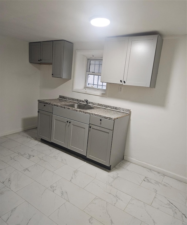 495 Milford St, Brooklyn, NY 11208 - kitchen featuring gray cabinets and light marble finish flooring