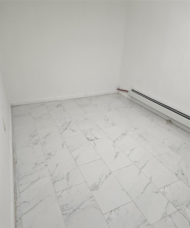 495 Milford St, Brooklyn, NY 11208 - empty room with marble look tile flooring and a baseboard heating unit