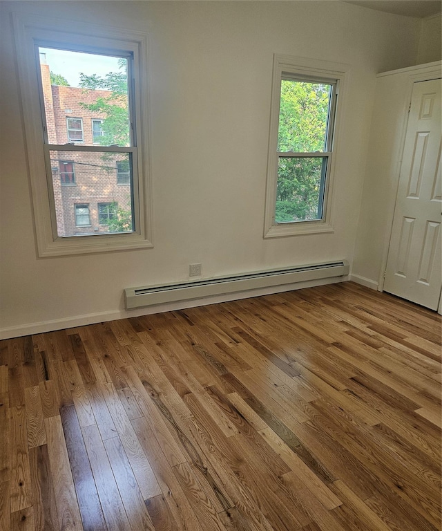 495 Milford St, Brooklyn, NY 11208 - unfurnished room featuring a baseboard heating unit and hardwood / wood-style floors