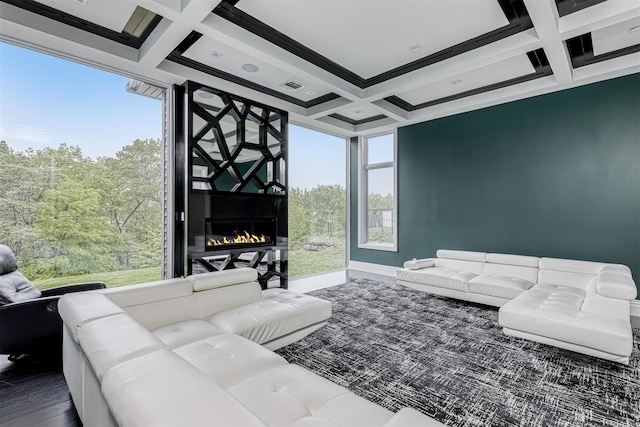 living room featuring coffered ceiling, a fireplace, beam ceiling, and baseboards