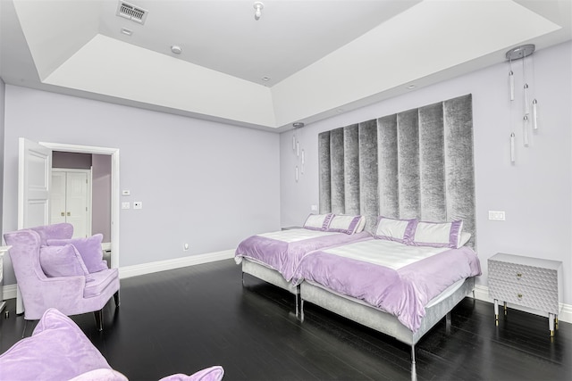 bedroom featuring baseboards and wood finished floors