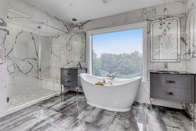 full bath with marble finish flooring, vanity, a marble finish shower, and healthy amount of natural light